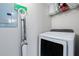 Laundry room features a new Samsung washer and dryer, storage shelves, with light gray colored walls at 3301 Haviland Ct # 203, Palm Harbor, FL 34684