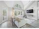 Living room boasts vaulted ceiling, large windows, modern floors, and stylish contemporary decor at 3301 Haviland Ct # 203, Palm Harbor, FL 34684