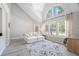 Bright living room with vaulted ceiling, large windows, modern rug and gray wood-look floors at 3301 Haviland Ct # 203, Palm Harbor, FL 34684