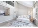 Open-concept living room with kitchen view, vaulted ceilings, and modern gray wood-look floors at 3301 Haviland Ct # 203, Palm Harbor, FL 34684
