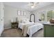 Cozy main bedroom featuring neutral tones, ceiling fan, window views, and tasteful decorations at 3301 Haviland Ct # 203, Palm Harbor, FL 34684