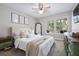 Relaxing main bedroom with light color palette, ceiling fan, and plush bedding at 3301 Haviland Ct # 203, Palm Harbor, FL 34684