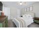 Bright main bedroom with neutral color palette, plush bedding and natural light at 3301 Haviland Ct # 203, Palm Harbor, FL 34684