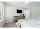 Bedroom with flat screen tv and wooden cabinet in a neutral color scheme at 3301 Haviland Ct # 203, Palm Harbor, FL 34684