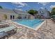Community pool with inviting lounge chairs and beautiful landscaping at 3301 Haviland Ct # 203, Palm Harbor, FL 34684