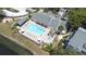 Aerial view of the community pool, hot tub, and lounge area at 3301 Haviland Ct # 203, Palm Harbor, FL 34684