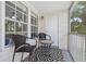Inviting screened in porch with outdoor seating for relaxing at 3301 Haviland Ct # 203, Palm Harbor, FL 34684