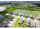 An aerial view of the houses in a community nestled around a lake and green spaces at 33287 Sycamore Leaf Dr, Wesley Chapel, FL 33545
