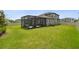 Expansive fenced-in backyard with a covered patio and screened lanai, perfect for outdoor enjoyment at 33287 Sycamore Leaf Dr, Wesley Chapel, FL 33545