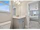 Bright bathroom features a vanity with gray cabinet, white countertop, and a view to the bedroom at 33287 Sycamore Leaf Dr, Wesley Chapel, FL 33545