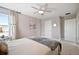 Cozy bedroom with large bed, ceiling fan, and natural light streaming through the window at 33287 Sycamore Leaf Dr, Wesley Chapel, FL 33545