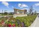 Whispering Oaks Preserve community sign surrounded by vibrant flowers and landscaping at 33287 Sycamore Leaf Dr, Wesley Chapel, FL 33545