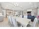 Bright dining area open to the living room, showcasing a modern chandelier and stylish furnishings at 33287 Sycamore Leaf Dr, Wesley Chapel, FL 33545