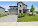 Charming two-story home with stone accents, well-maintained landscaping, and a paved driveway at 33287 Sycamore Leaf Dr, Wesley Chapel, FL 33545