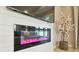 Close-up of the modern fireplace with color-changing lights and a mounted TV above at 33287 Sycamore Leaf Dr, Wesley Chapel, FL 33545