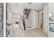 Inviting foyer with hardwood floors, staircase, and an open view to the living room at 33287 Sycamore Leaf Dr, Wesley Chapel, FL 33545