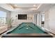 The expansive game room boasts a pool table, television, and neutral tones, perfect for entertaining at 33287 Sycamore Leaf Dr, Wesley Chapel, FL 33545