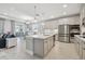 Open concept kitchen features pendant lighting, stainless appliances and transitions into the living and dining areas at 33287 Sycamore Leaf Dr, Wesley Chapel, FL 33545