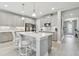 Beautiful kitchen with a center island, stainless steel appliances, modern cabinets and stylish backsplash at 33287 Sycamore Leaf Dr, Wesley Chapel, FL 33545