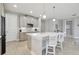 Kitchen featuring white countertops, light wood floors, ample cabinets and an island with barstool seating at 33287 Sycamore Leaf Dr, Wesley Chapel, FL 33545