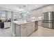 Kitchen island features quartz countertops, pendant lighting and stainless dishwasher at 33287 Sycamore Leaf Dr, Wesley Chapel, FL 33545