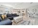 Open-concept living space flows into the kitchen, featuring a large sectional and stylish furnishings at 33287 Sycamore Leaf Dr, Wesley Chapel, FL 33545