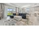 Spacious living room with a large sectional sofa, sliding glass doors to the backyard, and contemporary decor at 33287 Sycamore Leaf Dr, Wesley Chapel, FL 33545