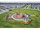 Aerial view of the neighborhood playground with a large green space and picnic tables at 33287 Sycamore Leaf Dr, Wesley Chapel, FL 33545