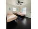 Shared bedroom featuring two beds, ceiling fan, and dark hardwood floors at 4049 Ponea Dr, Sarasota, FL 34241