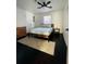 Inviting bedroom featuring a queen bed, ceiling fan, and minimalist decor at 4049 Ponea Dr, Sarasota, FL 34241