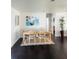 Bright dining room with a stylish table, seating for six, and hardwood floors at 4049 Ponea Dr, Sarasota, FL 34241