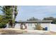 Charming single story home with a grey exterior, well-kept landscaping, and gravel driveway at 4049 Ponea Dr, Sarasota, FL 34241