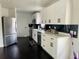 A bright kitchen with stainless steel appliances, white cabinetry and black marble-style backsplash at 4049 Ponea Dr, Sarasota, FL 34241