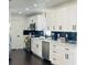 A bright kitchen with stainless steel appliances, white cabinetry and black marble-style backsplash at 4049 Ponea Dr, Sarasota, FL 34241