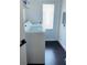 Bright laundry room featuring a full-size washer and dryer near an exterior door at 4049 Ponea Dr, Sarasota, FL 34241