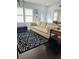 Bright living room featuring a comfortable sofa, stylish rug, and dark hardwood floors at 4049 Ponea Dr, Sarasota, FL 34241