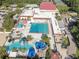 Aerial view of the community pool featuring a large swimming area, waterslides, and a playground at 415 Mission Hills Ave, Temple Terrace, FL 33617