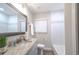 The bathroom features granite countertops, white tile backsplash, and a mirror at 415 Mission Hills Ave, Temple Terrace, FL 33617