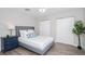 Comfortable bedroom featuring wood-look floors, ample closet space, and neutral paint at 415 Mission Hills Ave, Temple Terrace, FL 33617