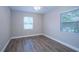 Bedroom featuring wood-look floors and lots of natural light, offering a comfortable space at 415 Mission Hills Ave, Temple Terrace, FL 33617
