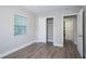 Bedroom with wood-look floors, closet and lots of natural light at 415 Mission Hills Ave, Temple Terrace, FL 33617
