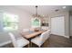 Bright dining area with a modern light fixture, seating for six, and natural light at 415 Mission Hills Ave, Temple Terrace, FL 33617