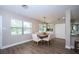 Inviting dining room featuring wood floors, a modern light fixture, and a view of the outdoors at 415 Mission Hills Ave, Temple Terrace, FL 33617