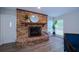 Close-up of brick fireplace, wood mantle and white door with privacy glass at 415 Mission Hills Ave, Temple Terrace, FL 33617