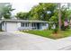 Charming single-story home with a well-maintained lawn, beautiful landscaping, and inviting curb appeal at 415 Mission Hills Ave, Temple Terrace, FL 33617