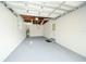 Spacious two-car garage with epoxy flooring and updated lighting at 415 Mission Hills Ave, Temple Terrace, FL 33617