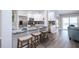 This gorgeous kitchen boasts white cabinets, granite countertops, stainless appliances, and breakfast bar at 415 Mission Hills Ave, Temple Terrace, FL 33617