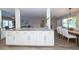Open-concept kitchen with a marble countertop island connecting the dining and living spaces at 415 Mission Hills Ave, Temple Terrace, FL 33617