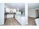 Bright kitchen features white cabinets, granite countertops, stainless appliances and wood flooring at 415 Mission Hills Ave, Temple Terrace, FL 33617