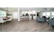 Open concept living room with new flooring, white walls, and lots of natural light at 415 Mission Hills Ave, Temple Terrace, FL 33617